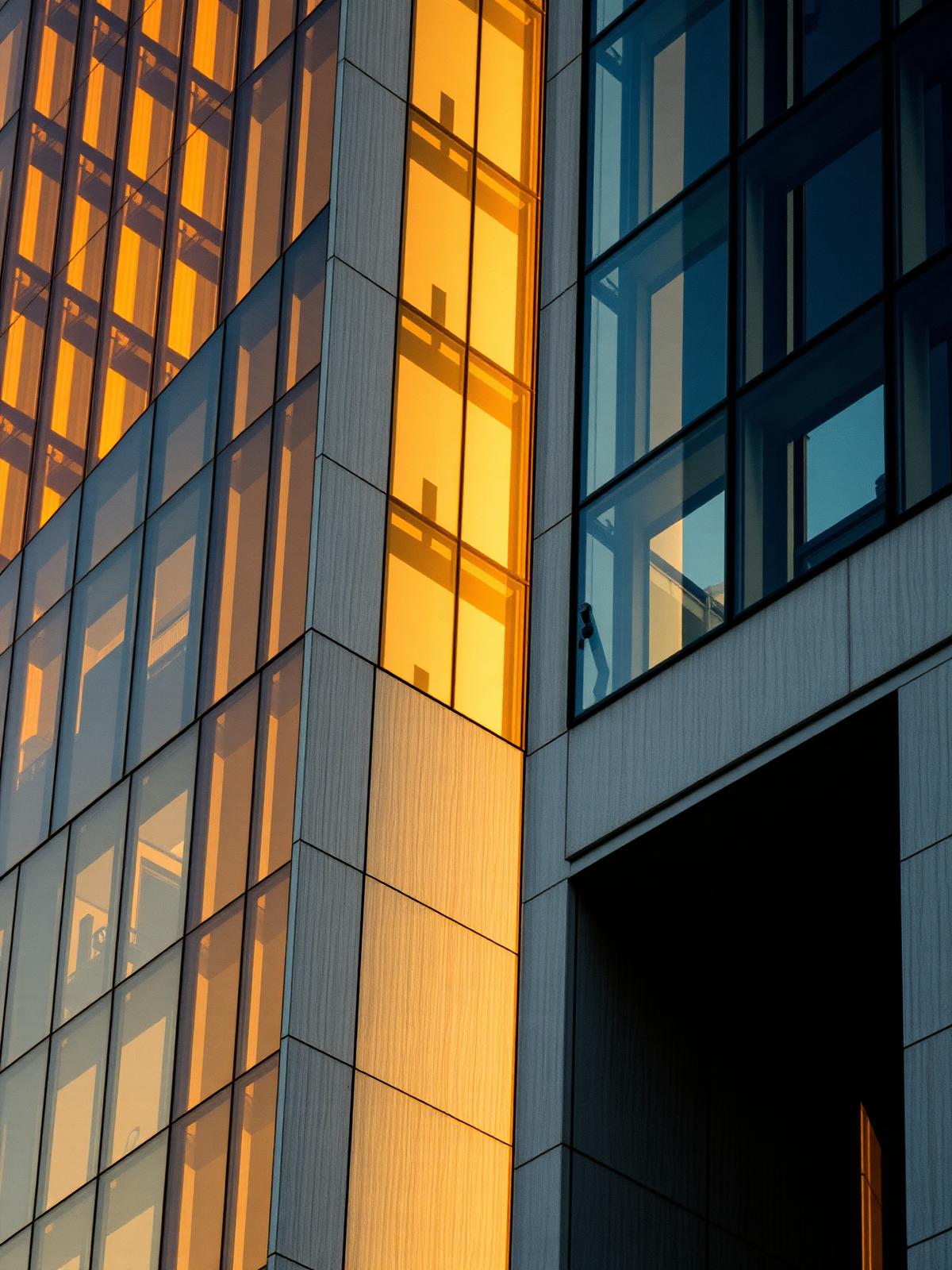 Modern luxury building reflecting golden hour light